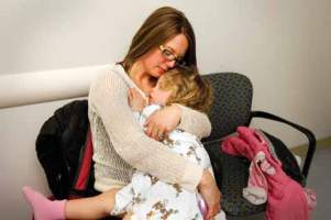 Rhonda Pottle cuddles her daughter Larkin Pottle as they wait for Larkin's appointment at the IWK.
